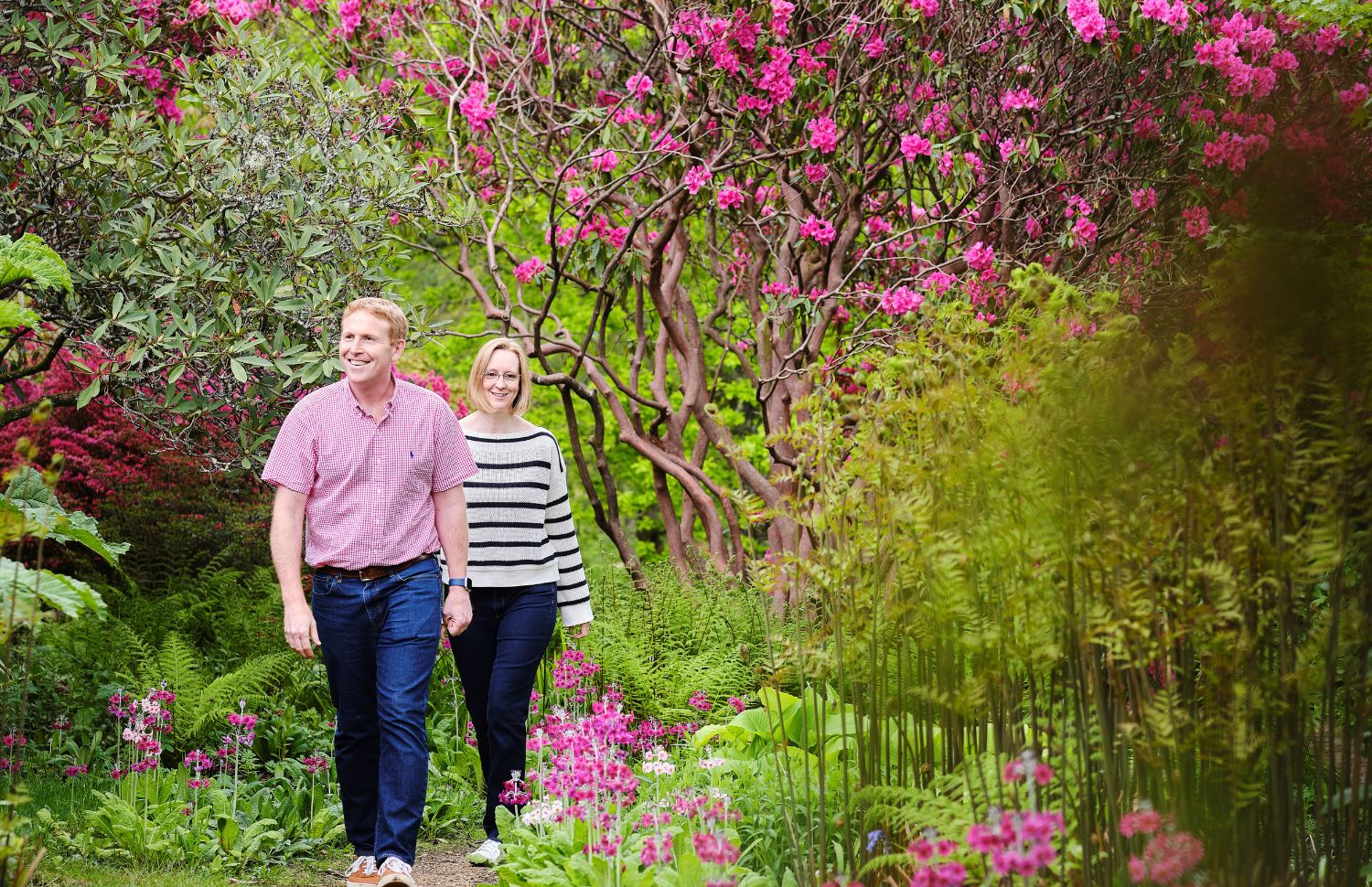 Young girl and boy exploring gardens in spring
