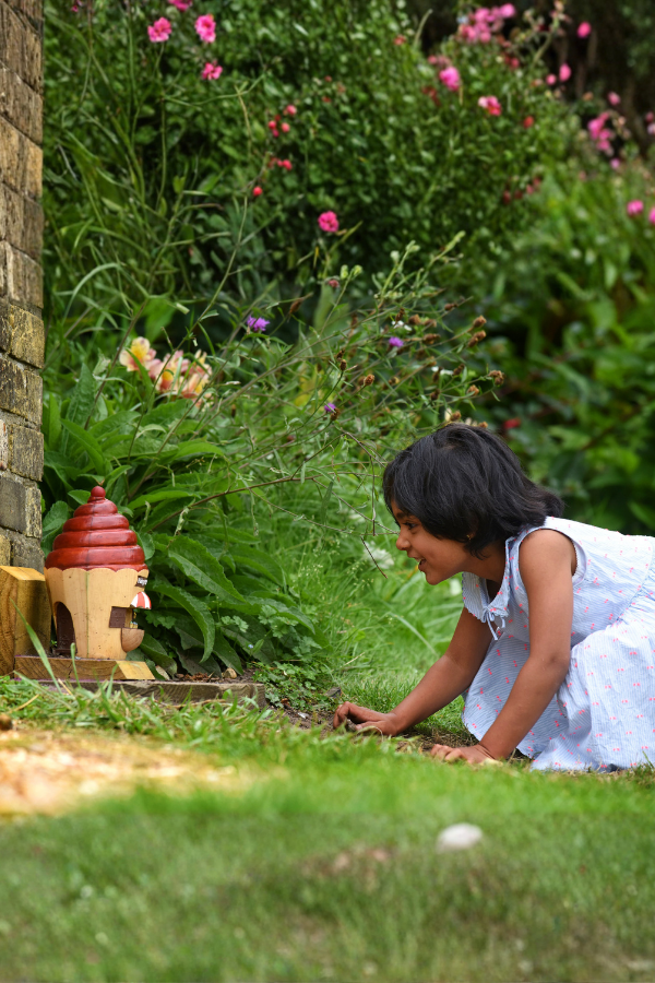 Girl looking at fairy door